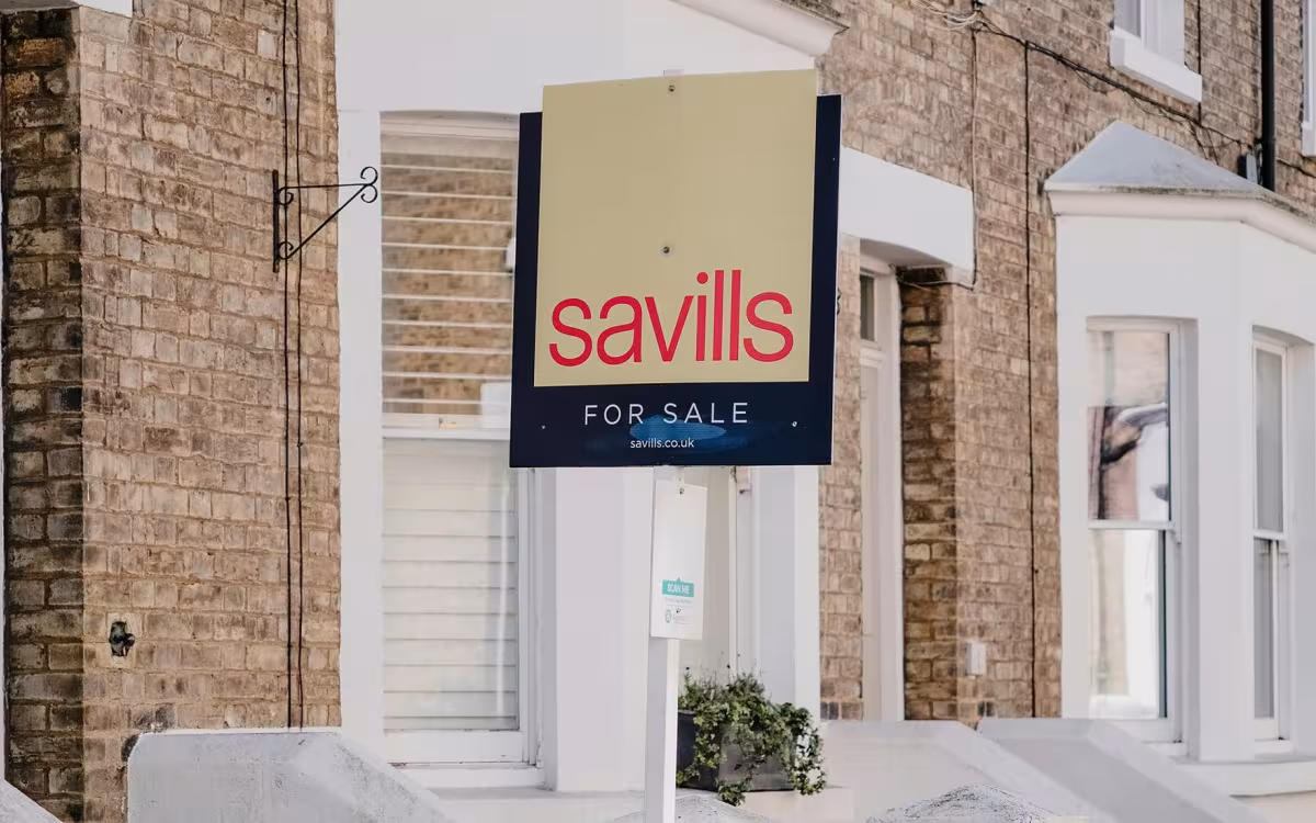 Estate agent property board displayed outside a residential home in the UK